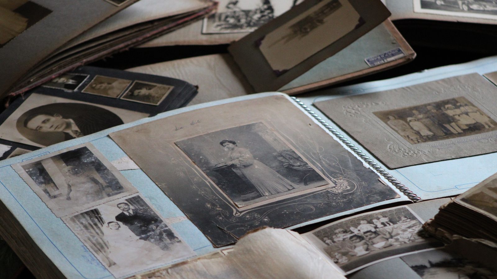 An old black and white family photo album lying open on a table, the main source for tracing the fourth and fifth generations