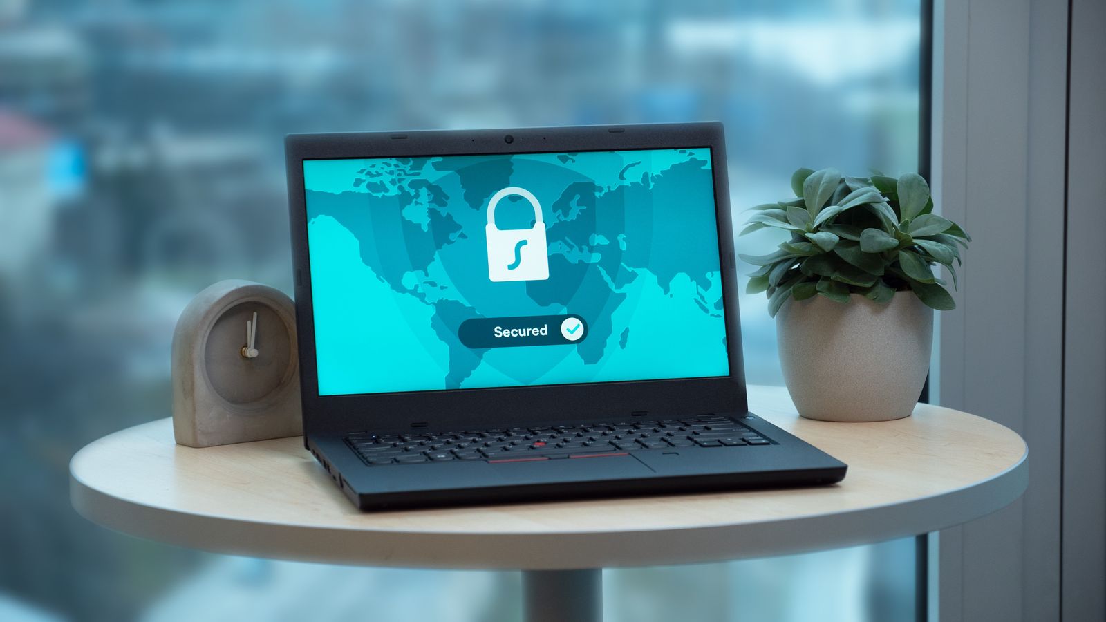 A laptop displaying a security lock icon, illustrating the protection of family lineage data