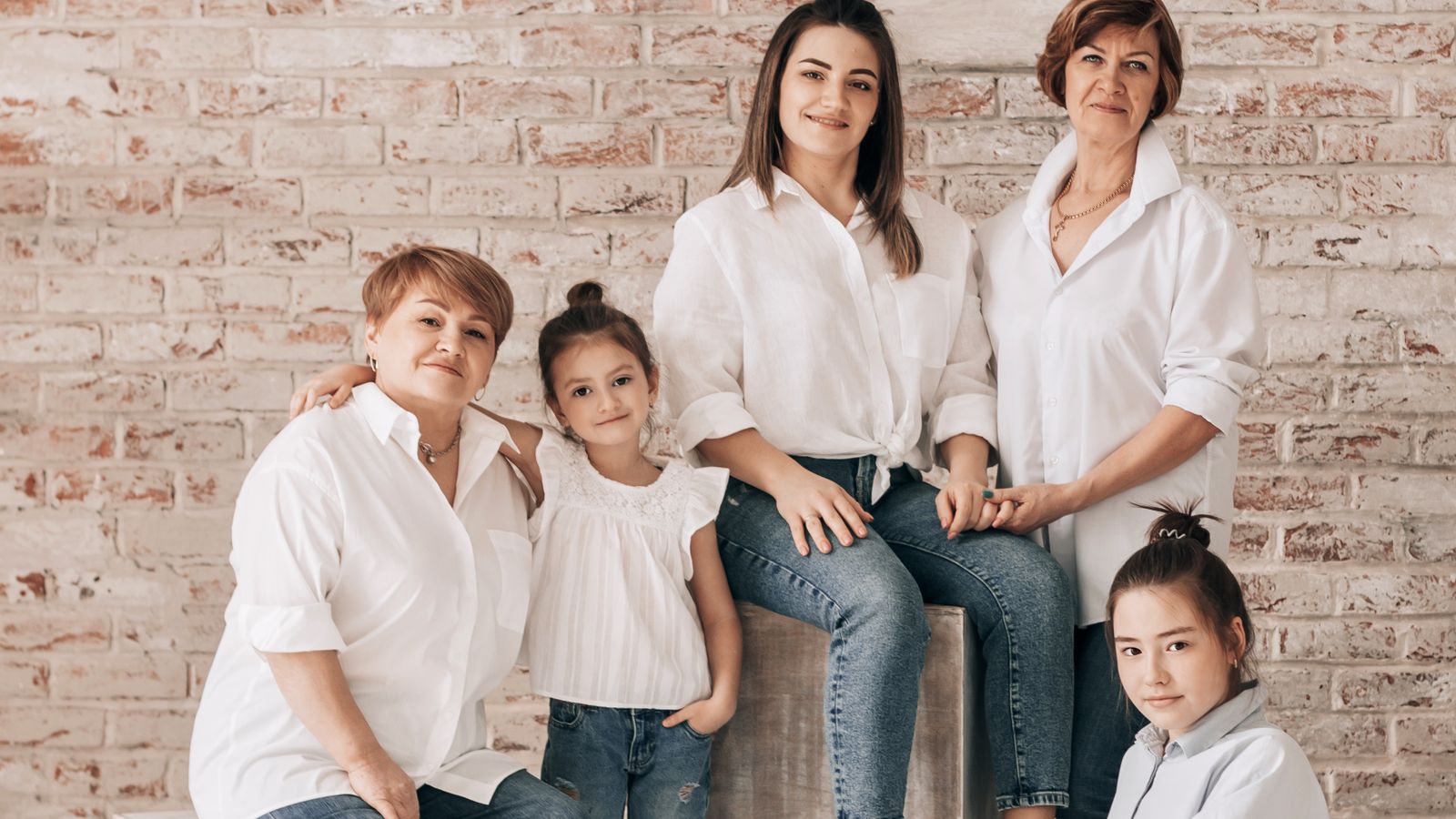Three generations of women in one family photographed together with a small child, illustrating generation levels in a family tree